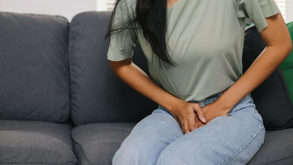 Woman Holding Her Lower Abdomen Due To Menstrual Pain - DR Vinayak das Blog